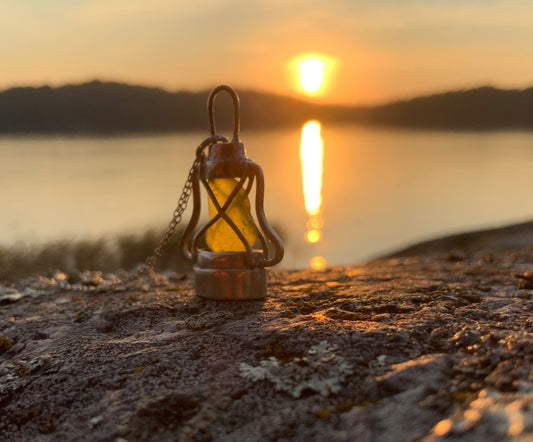 Käsintehty Myrskylyhty-koru auringonlaskussa