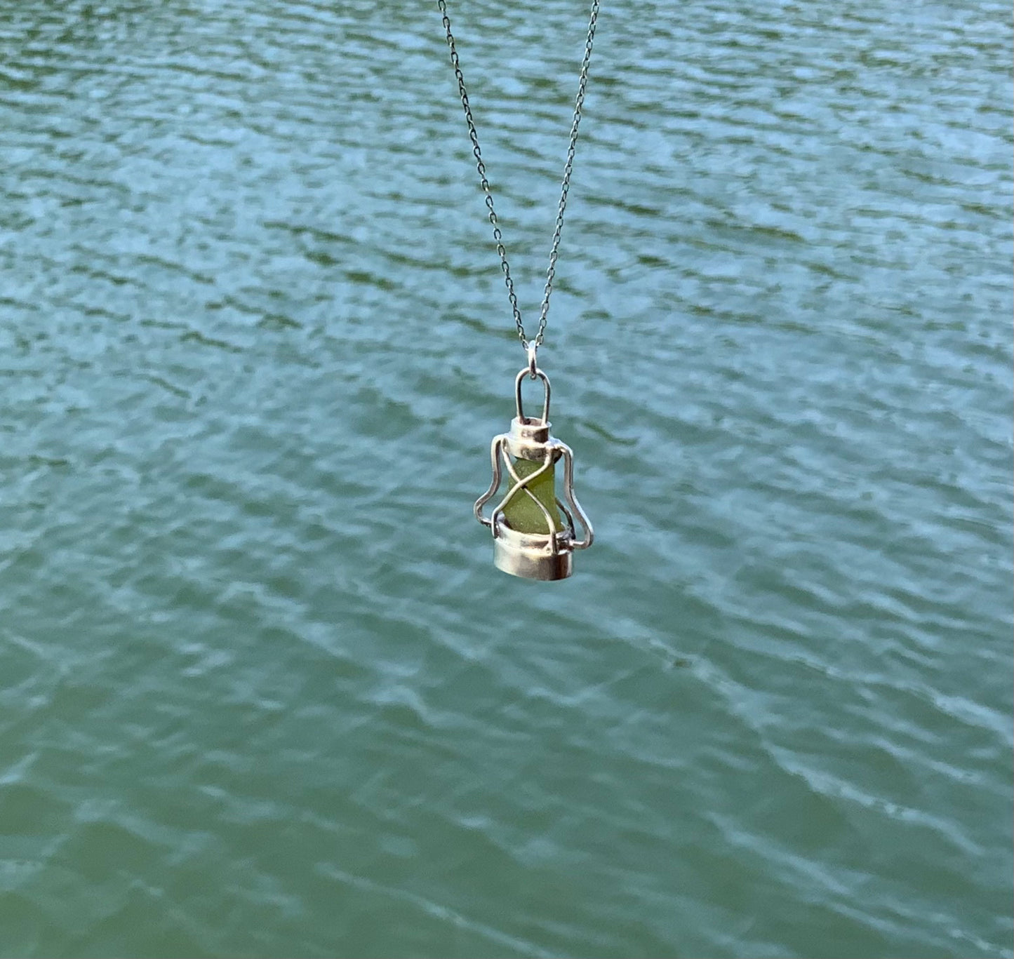 Handmade Storm lantern necklace sea background