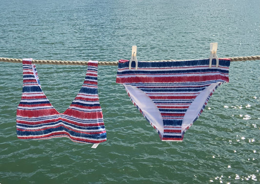 Nautical bikini hanging against Sea