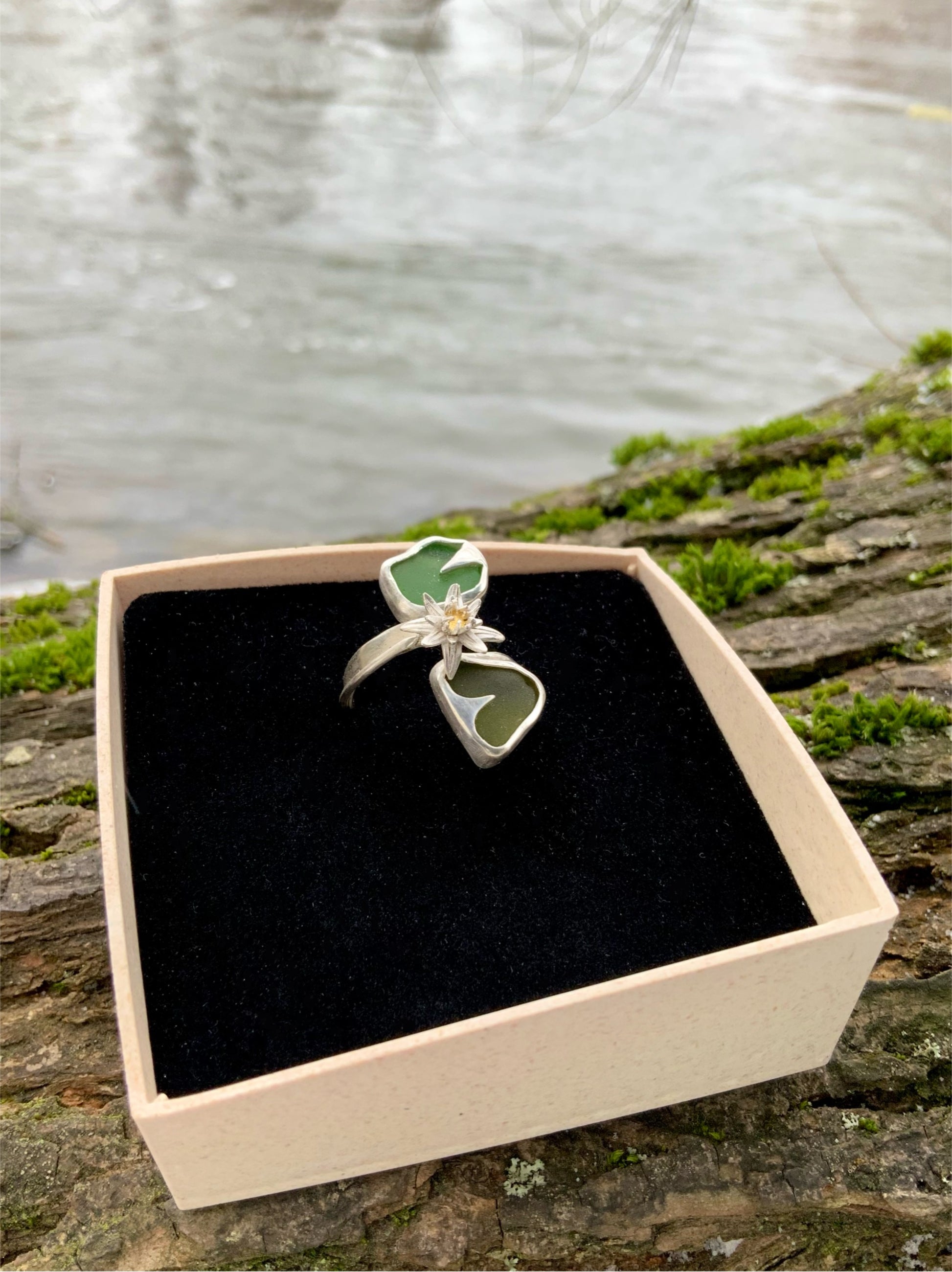 Handmade Waterlily ring in jewelry box against water