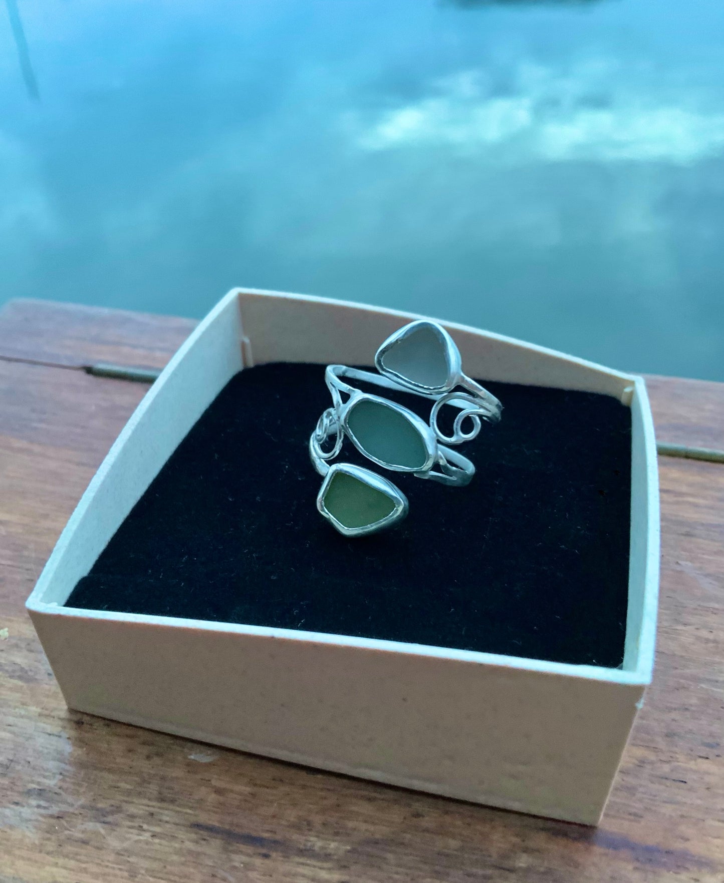 Seaside Fantasy silver and sea glass ring in jewelry box against sea